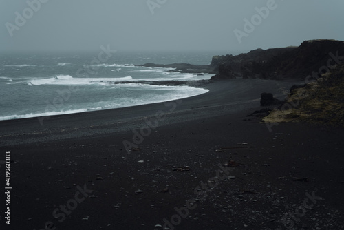 Western Iceland nature landscape. Djupalonssandur black sand beach in Snaefellsnes peninsula. Stormy waves at rainy weather