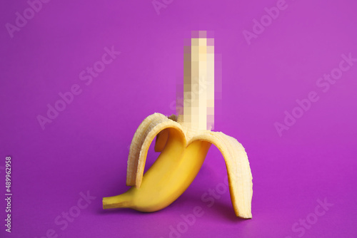Fresh banana on purple background. Sex concept