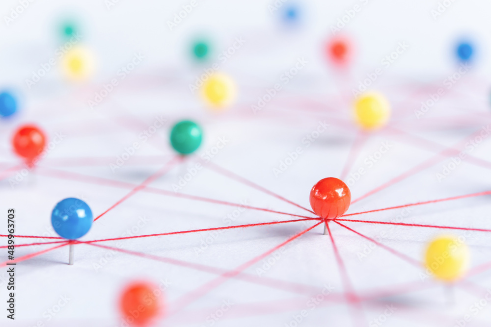 Linking entities, Blockchain, social media, Communications Network, The connection between the two networks. Network simulation on paper linked together by yarn Linking entities, Blockchain, social media, Communications Network, The connection between the two networks. Network simulation on paper linked together by yarn