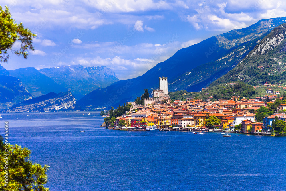 Idyllic lake scenery - beautiful Lago di Garda, view of Malcesine village surrounded by Alps mountains. North of Italy