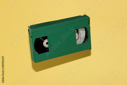 green old vhs cassette retro style on pastel yellow background