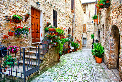 Fototapeta Naklejka Na Ścianę i Meble -  Charming floral narrow streets of typical italian villages. Spello in Umbria famous with fllower decorated walls. Italy