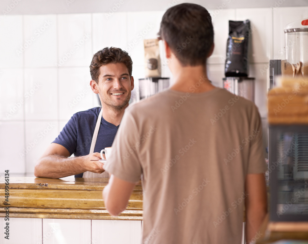 Best cuppa joe in town. A man buying a cup of coffee at a coffee shop. Best cuppa joe in town. A man buying a cup of coffee at a coffee shop.
