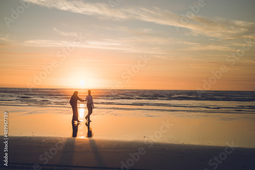 Married couple s silhouettes on the beach sunset