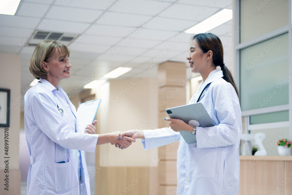 Male doctor and female doctor consulting, assessing, discussing in hospital. Male doctor and female doctor consulting, assessing, discussing in hospital.