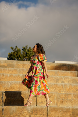 Low angle photo of a woman walking on big stairs