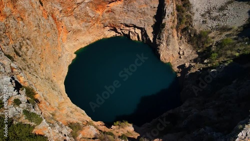 Wallpaper Mural A drone shot of Red Lake or Crveno jezero which is a collapsed sinkhole containing a karst lake close to Imotski, Croatia. It is 530 meters deep, thus it is the largest limestone crater in Europe. Torontodigital.ca