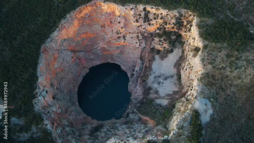 Red Lake (Croatian: Crveno jezero) is a collapse doline (collapse sinkhole) containing a karst lake close to Imotski, Croatia. It is 530 meters deep, thus it is the largest collapse doline in Europe. Red Lake (Croatian: Crveno jezero) is a collapse doline (collapse sinkhole) containing a karst lake close to Imotski, Croatia. It is 530 meters deep, thus it is the largest collapse doline in Europe.