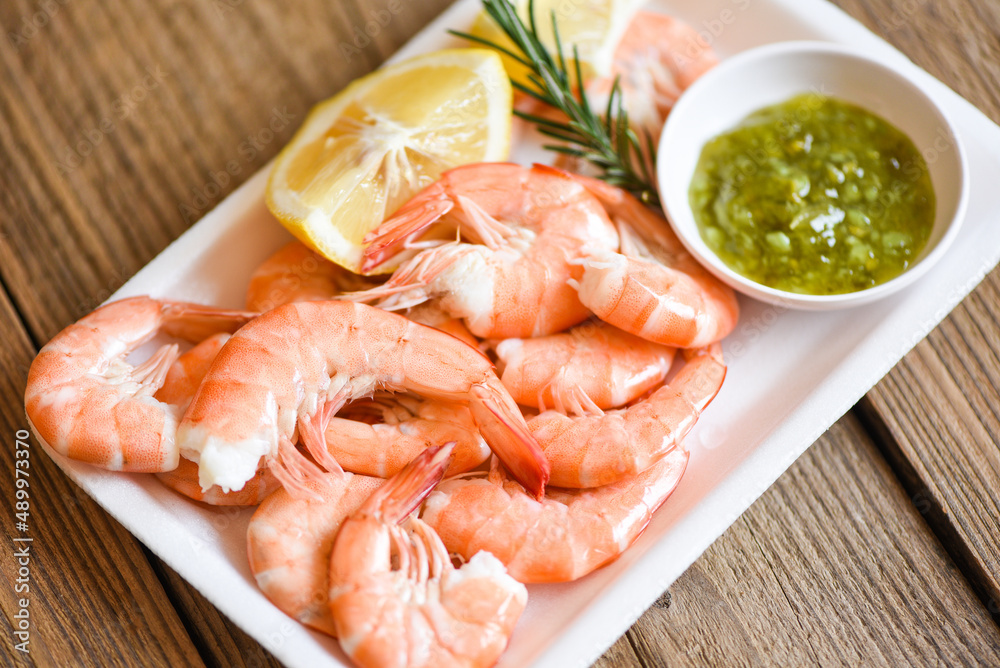 Fresh shrimps on on plate plastic tray with lemon, boiled shrimp prawns cooked food in the seafood restaurant Fresh shrimps on on plate plastic tray with lemon, boiled shrimp prawns cooked food in the seafood restaurant