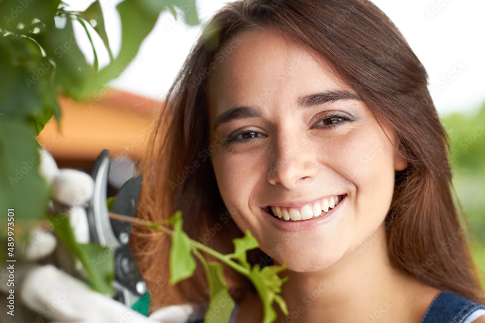 Shes passionate about gardening. Closeup portrait of an attractive young woman working in her garden. Shes passionate about gardening. Closeup portrait of an attractive young woman working in her garden.