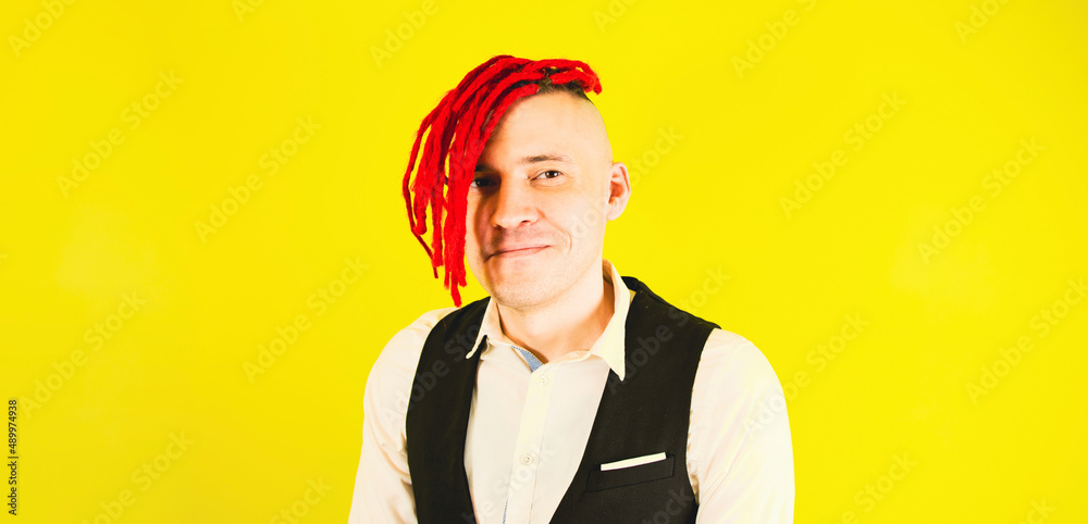 Close up of man hipster. Portrait businessman with red dreadlocks, isolated bright yellow color background Close up of man hipster. Portrait businessman with red dreadlocks, isolated bright yellow color background