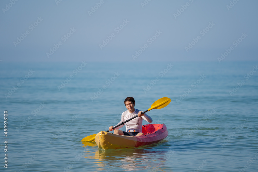 man paddling a kayak boat in sea