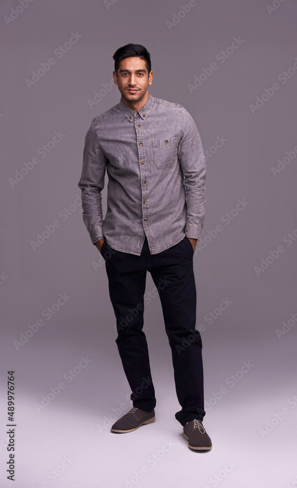 Casual confidence. Studio shot of a handsome young man isolated on gray. Casual confidence. Studio shot of a handsome young man isolated on gray.
