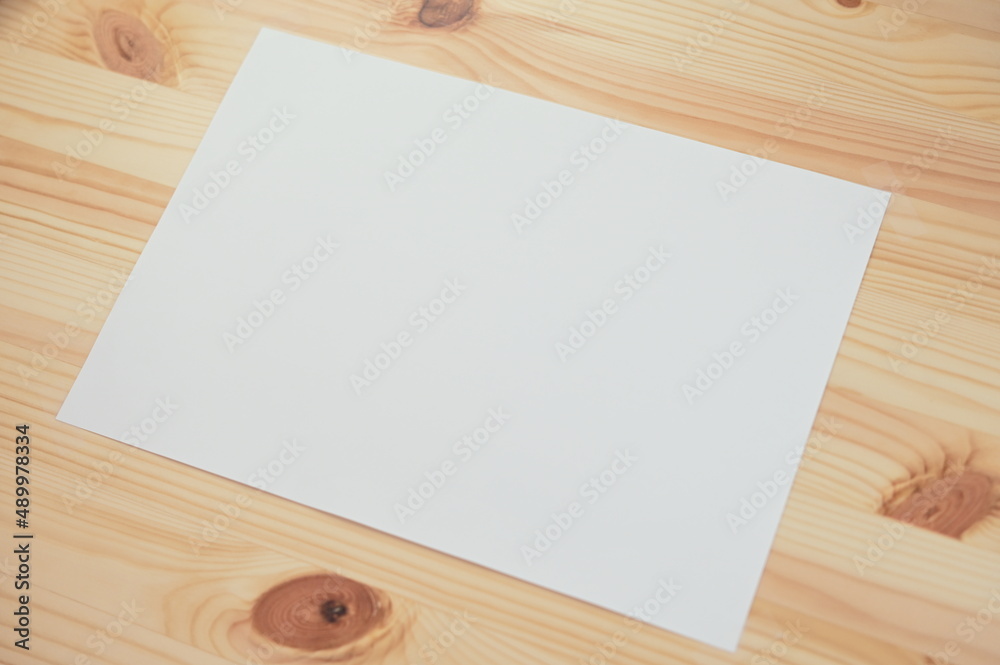 white paper on wood table white paper on wood table