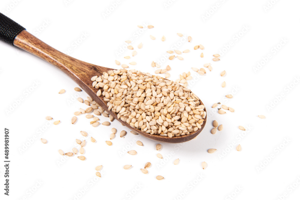 sesame seeds in spoon isolated on white background sesame seeds in spoon isolated on white background
