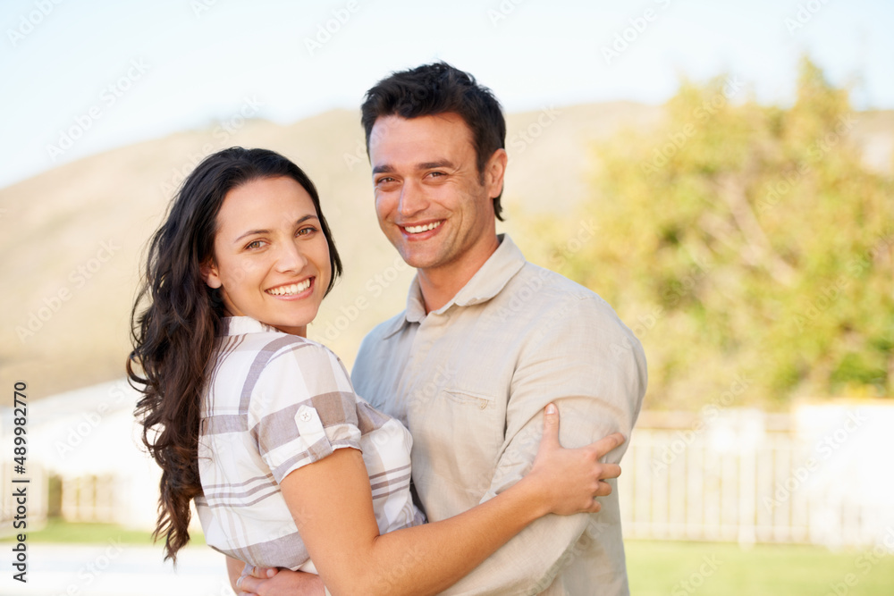 Fototapeta premium They are fantastic together. A cute couple embracing outdoors.