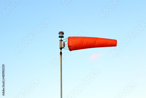 A windsock flying in the wind against a blue sky photo
