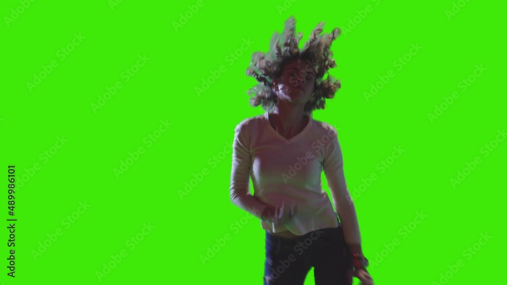 A positive girl is dancing in front of crowd in slow-motion on greenscreen A positive girl is dancing in front of crowd in slow-motion on greenscreen