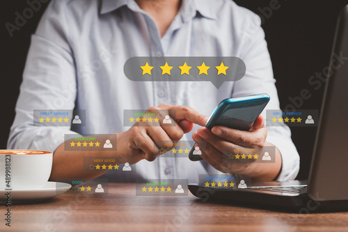 Картината върху платно Man using a smartphone give the five-star icon a rating of very impressed for se