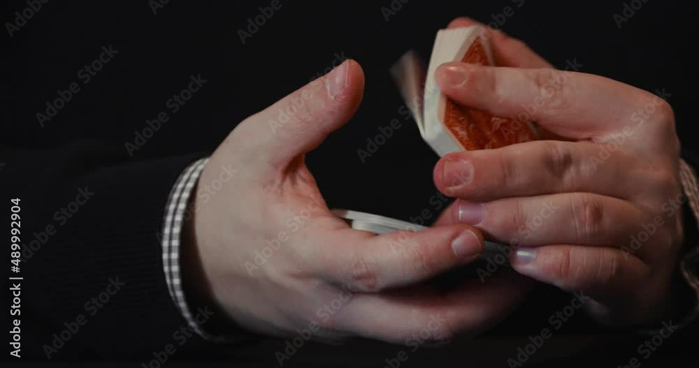 Close up of a pair of hands and a deck of playing cards showing off with tricks, flourish and spread in 4K. Close up of a pair of hands and a deck of playing cards showing off with tricks, flourish and spread in 4K.