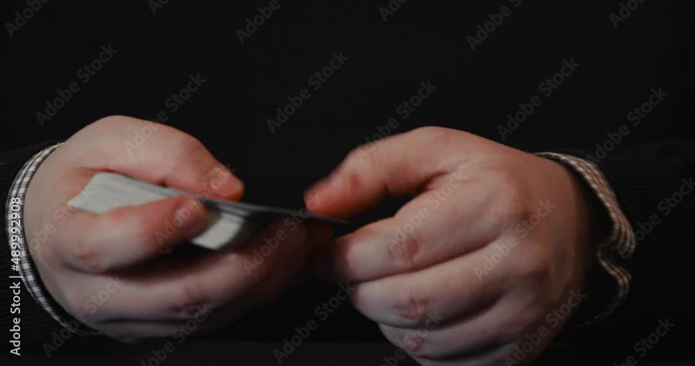 Close up of a pair of hands showcasing two techniques on how to hide a card in a deck of cards. 4K. Close up of a pair of hands showcasing two techniques on how to hide a card in a deck of cards. 4K.