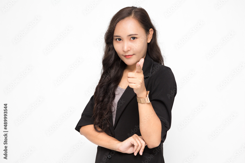 Beautiful Asian business woman wearing black suit pointing finger at camera presenting something on white background and copy space. Confident Asian working woman smiling and cheerful Beautiful Asian business woman wearing black suit pointing finger at camera presenting something on white background and copy space. Confident Asian working woman smiling and cheerful