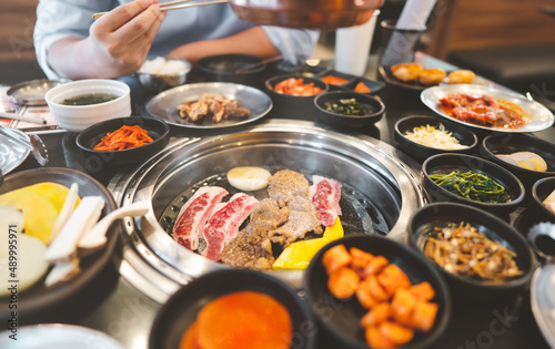 Photography Korea bbq style restaurant  with meat and vegetable side dish.