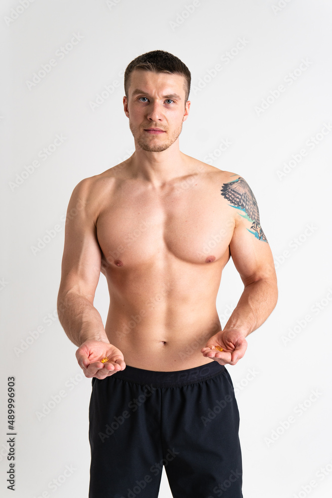 Fototapeta premium Fish oil is eaten by a man in the hands of vials and a glass bottle pill health supplement, medical yellow lifestyle, cod. white translucent, eat female giving dieting