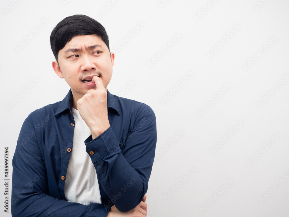 Man gesture biting nails feeling serious and thinking something looking at copy space Man gesture biting nails feeling serious and thinking something looking at copy space