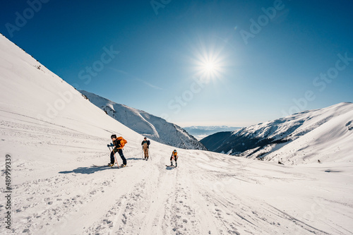 Ziarska dolina, slovakia, 10.2.2022. Mountaineer backcountry ski walking ski alpinist in the mountains. Ski touring in alpine landscape with snowy trees. Adventure winter sport. photo