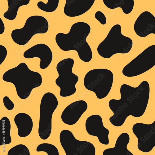 Trendy seamless pattern of spotted animal skins. Abstract print in black yellow  colors. Vector illustration	