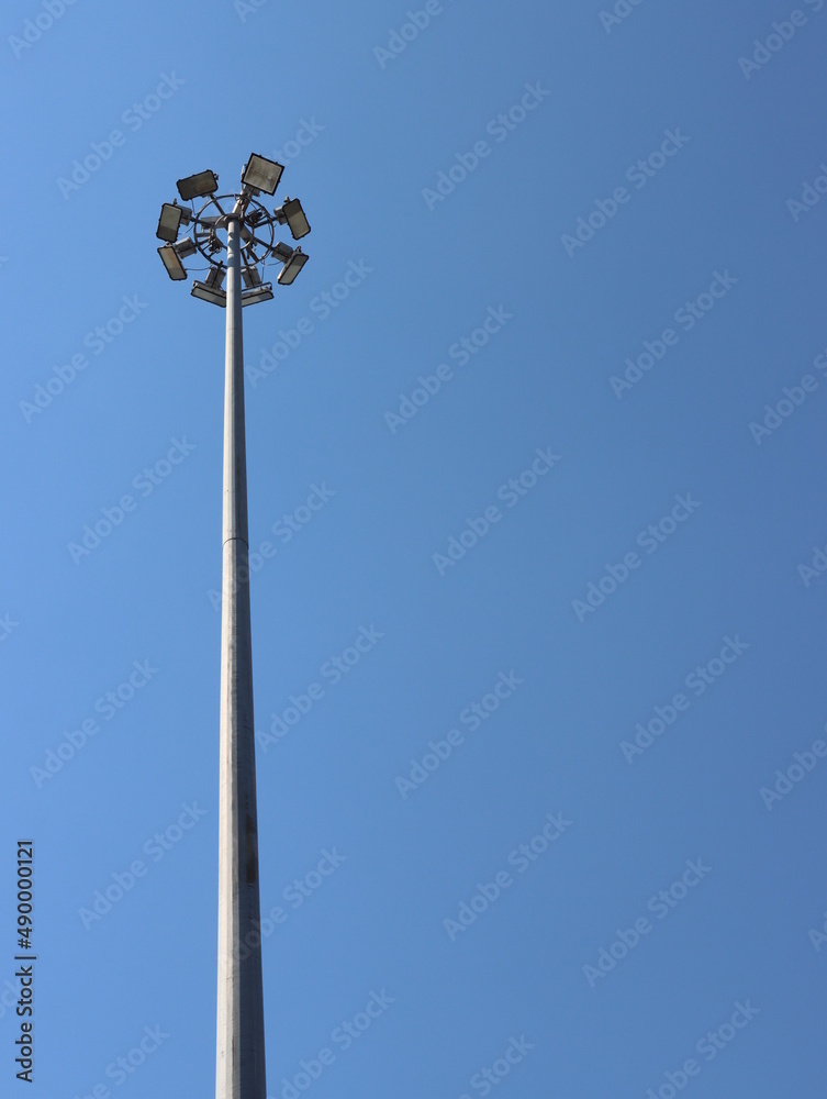 A large lamppost against a bright sky background.