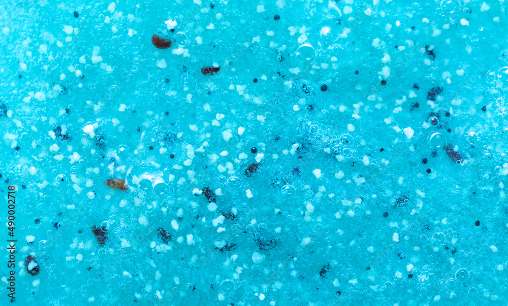Body scrub close-up of blue color, particles of exfoliating ingredients, bubbles. Gel for cleansing the skin of the face and body. Spa treatments, skin care. kiwi seaweed goo lime green aqua