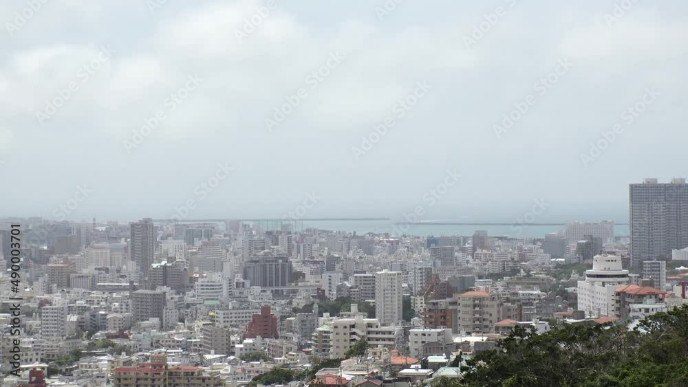 NAHA, OKINAWA, JAPAN - AUGUST 2021 : Aerial high angle view of Naha city. Cityscape of downtown area and sunny blue sky. Time lapse shot in daytime. Summer holiday, vacation and travel concept video. NAHA, OKINAWA, JAPAN - AUGUST 2021 : Aerial high angle view of Naha city. Cityscape of downtown area and sunny blue sky. Time lapse shot in daytime. Summer holiday, vacation and travel concept video.