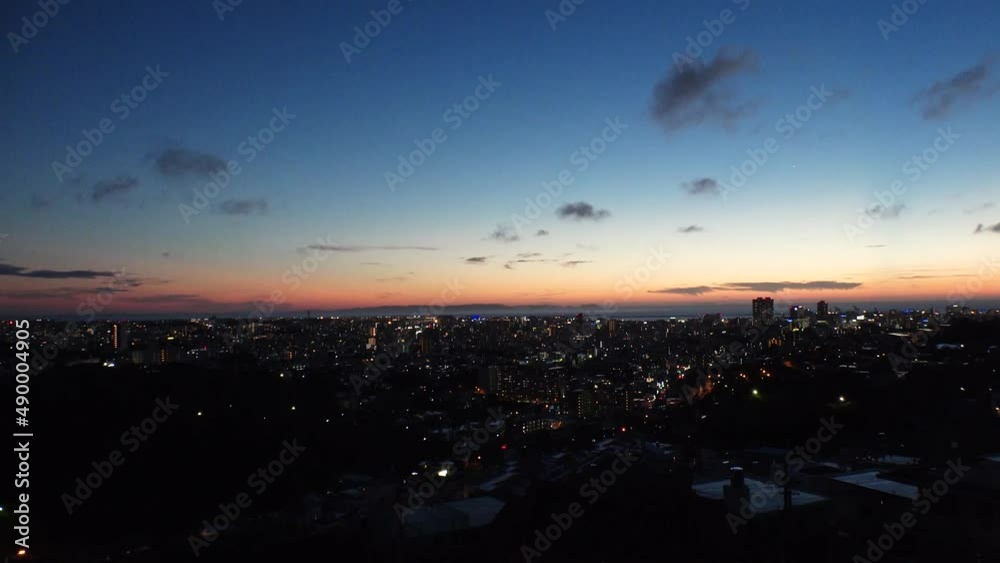 NAHA, OKINAWA, JAPAN - AUG 2021 : Aerial sunrise view of Naha city. Cityscape of downtown area. High angle wide view, time lapse shot night to morning. Summer holiday, vacation and travel concept. NAHA, OKINAWA, JAPAN - AUG 2021 : Aerial sunrise view of Naha city. Cityscape of downtown area. High angle wide view, time lapse shot night to morning. Summer holiday, vacation and travel concept.
