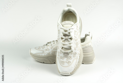 Pair of trendy sneakers on a white background. Close-up