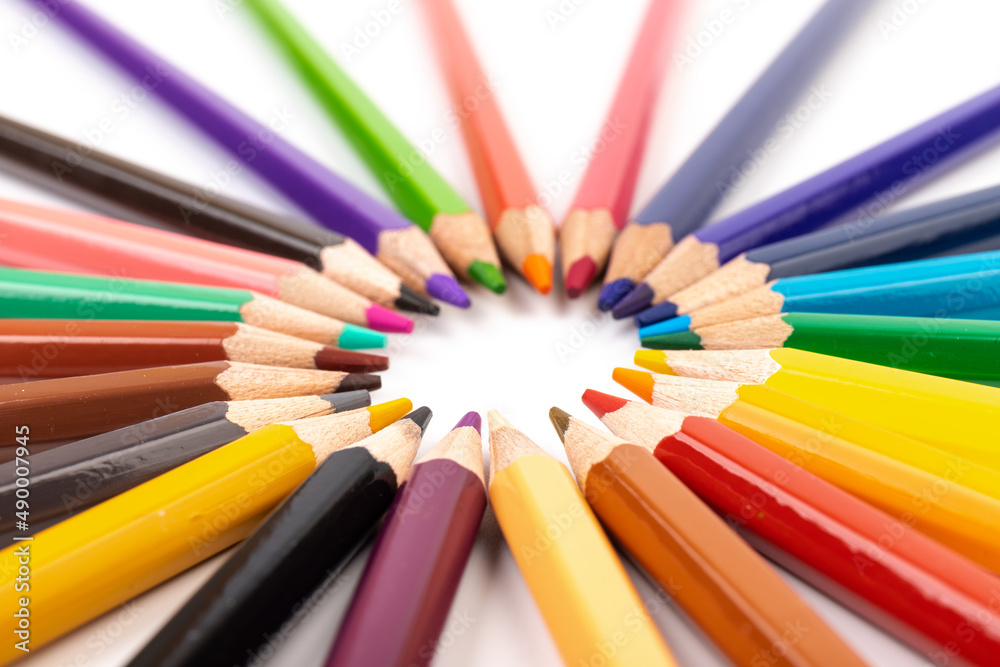 Many multicolored pencils, isolated on white background with copy space. Art and education background. Many multicolored pencils, isolated on white background with copy space. Art and education background.