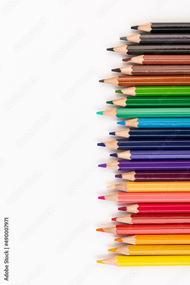 Many multicolored pencils, isolated on white background with copy space. Art and education background.