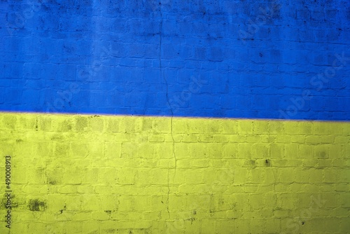 Flag of Ukraine painted brick wall yellow blue grungy texture background