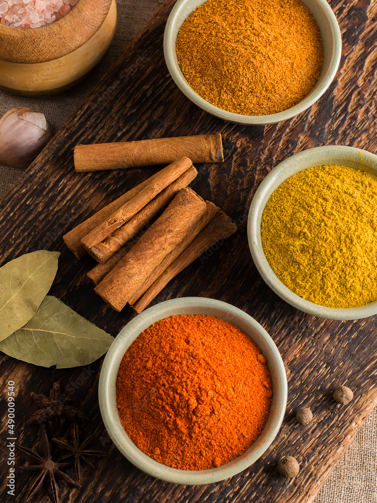 seasonings for cooking spicy dishes on a wooden background. seasonings for cooking spicy dishes on a wooden background.