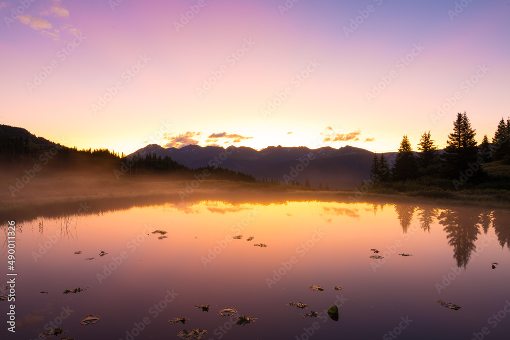 Reflected Sunrise Over Mountains