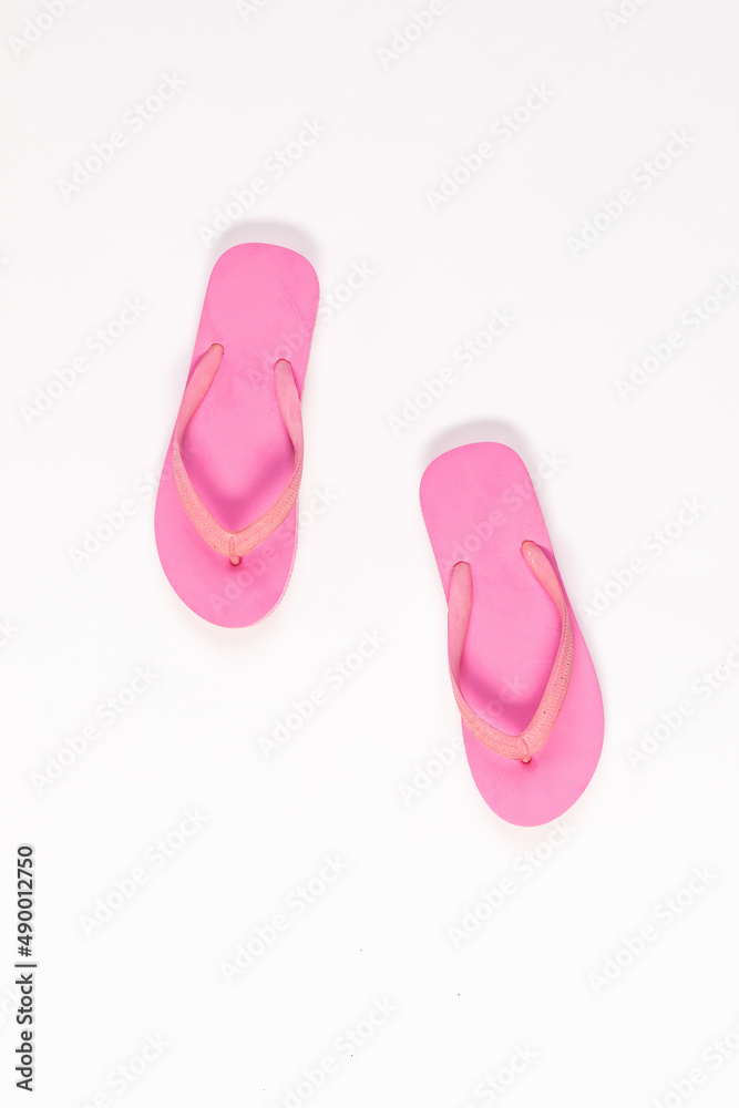 Closeup top view studio isolated shot pair of fashionable beautiful bright pink casual comfortable unisex rubber material slipper, flip flop, sandal, footwear on white background with copy space. Closeup top view studio isolated shot pair of fashionable beautiful bright pink casual comfortable unisex rubber material slipper, flip flop, sandal, footwear on white background with copy space.