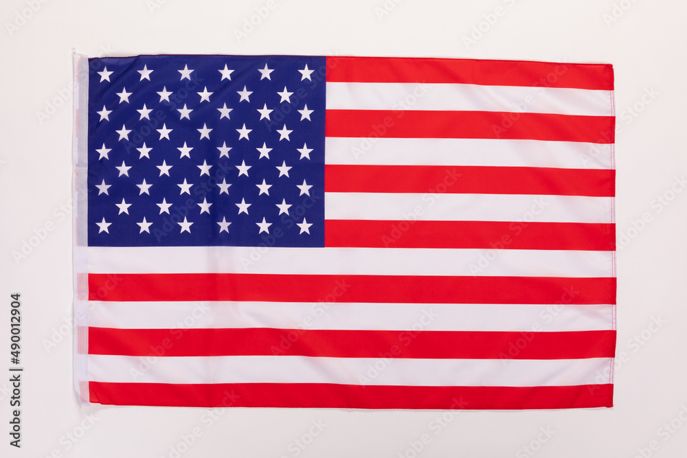 Closeup studio isolated top view shot of pride patriotism blue and red striped star American nation USA United States of America country national fabric clothing unity flag placed on white background