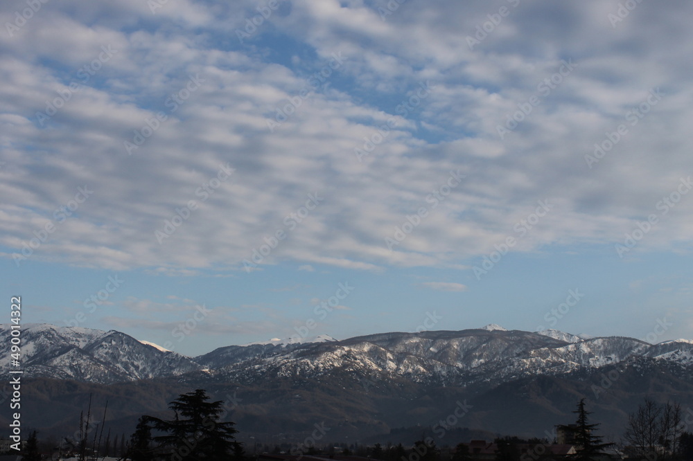 snow covered mountains and sky