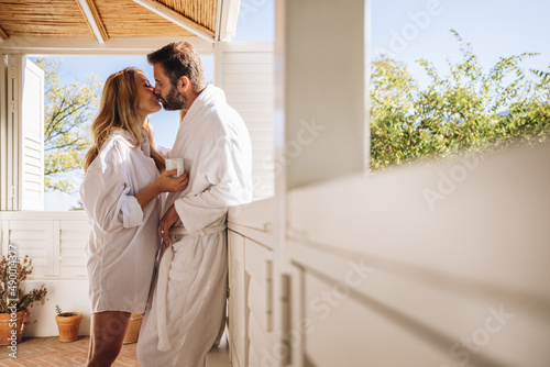 Affectionate couple kissing on a balcony photo