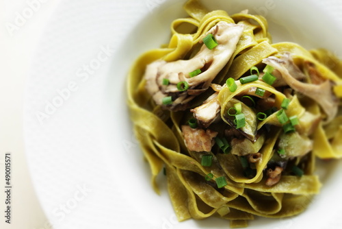 Homemade Italian food, eggplant and mushroom with spinach fettuccine serving with sesame bread © jreika