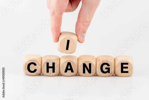 A hand lays with single letters I change