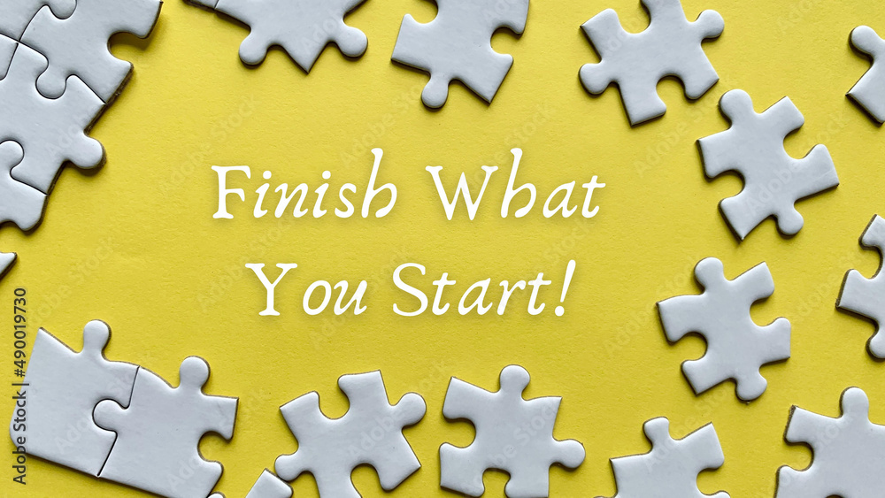 Obraz premium Finish what you start text on yellow background with white jigsaw puzzle missing pieces.