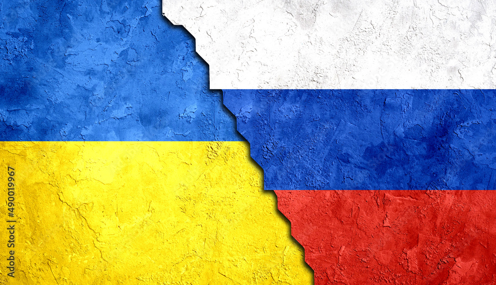 Flag of Ukraine and Russia Painted on a Grungy wall with Ukrainian and Russian Flags.  Ukraine-Russia Conflict  Concept 