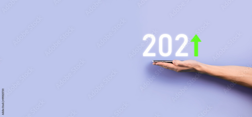 Fototapeta premium Business development to success and growing growth year 2021 concept.Plan business growth graph in year 2021 concept.Businessman plan and increase of positive indicators in his business